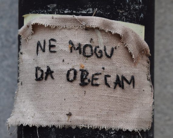 Fabric with handwritten text on a pole